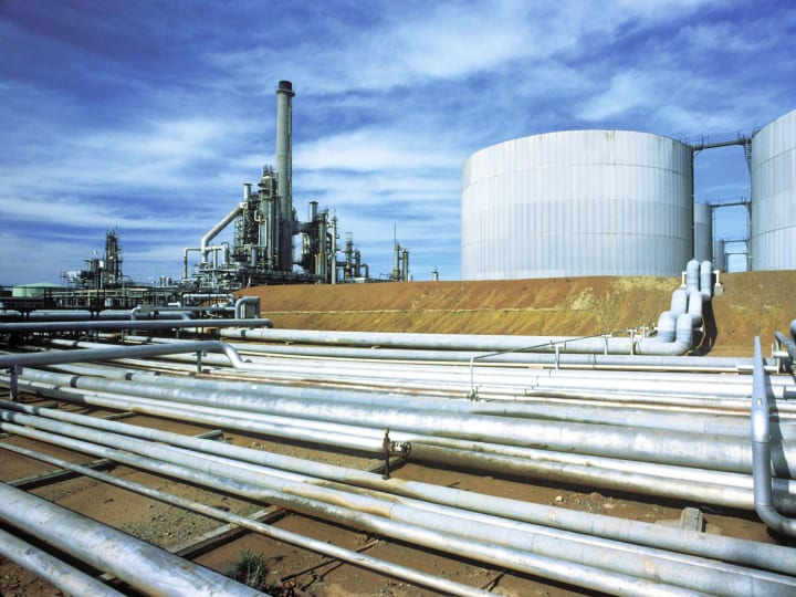 Steel pipelines in front of an industrial plant Steel pipelines in front of an industrial plant
